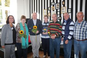 Die ehrenamtlichen Mitgleider von "Senioren Online" stehen im Halbkreis, gemeinsam mit Iris Schieferdecker vom Seniorentreff der Stadt. Die Teilnehmer halten Blumen in den Händen, die sie zum Dank erhalten haben.