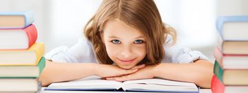pretty girl with many books at school