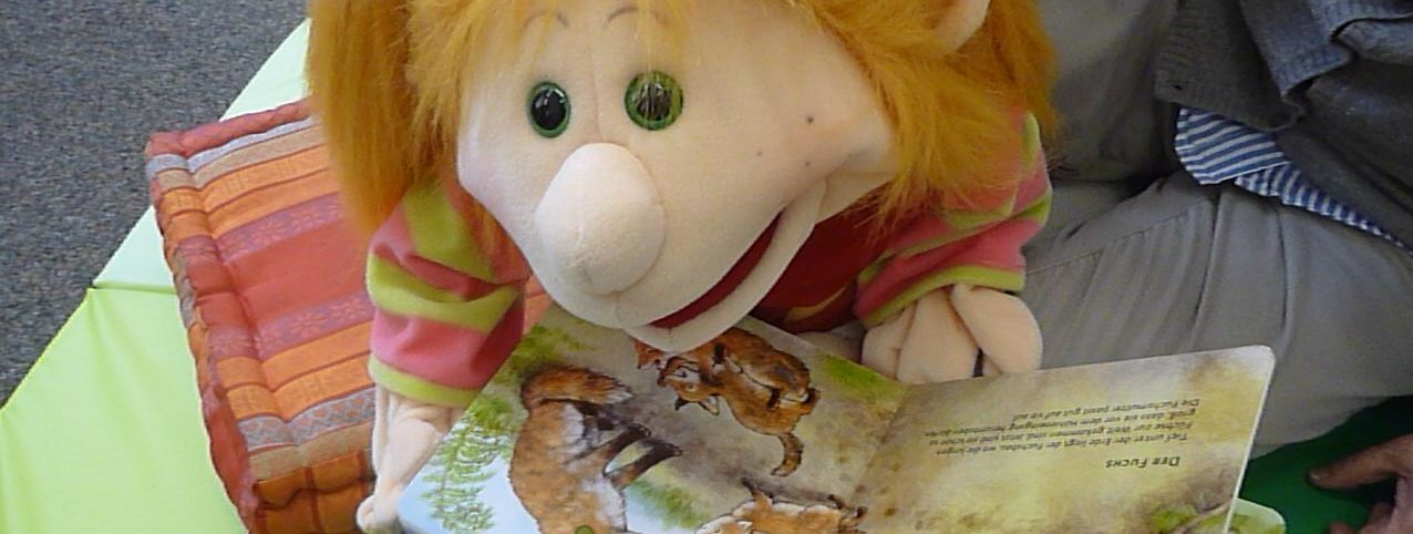 Handpuppe mit Bilderbuch